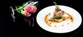 Elegant plated gourmet dish with floral garnish for luxury private chef service in Australia.