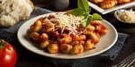 Fresh homemade gnocchi served with cheese and basil, perfect for private chef dining in Australia.