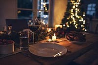 Elegant dinner table setup with Christmas decorations and fine dining essentials in Sydney.