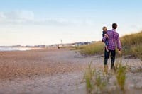 Elegant couple walking on the beach, enjoying a private chef experience in Australia.