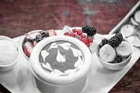 Luxurious gourmet desserts with fresh berries and edible flowers for private chef experiences.