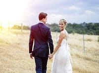 Elegant couple holding hands outdoors, wedding celebration, romantic event, Your Private Chef special occasion.