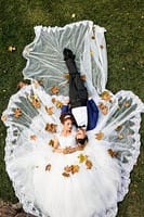 Elegant bride lying on the lush grass with a floral canopy, perfect for luxury wedding events in Australia.