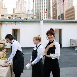 Experienced private chefs preparing gourmet dishes at an exclusive rooftop event in Australia.