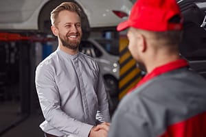 Happy customer and mechanic in workshop