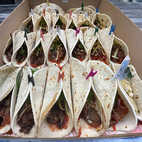 Taco with pulled beef, shredded cheddar, jalapeños, smokey salsa